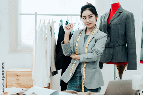 Asian young women fashion designer working on her designer in the showroom, Lifestyle Stylish tailor taking measurements on mannequin in studio Tableau sur Toile