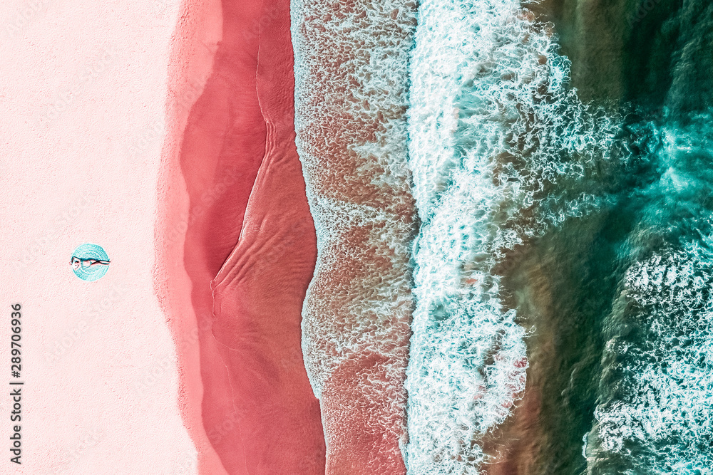 Aerial View Of Woman On Pink Ocean Beach - obrazy, fototapety, plakaty 