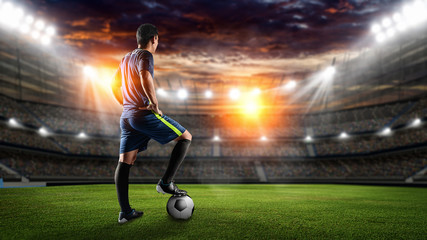 Soccer players in action on sunset stadium background