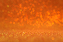 Background Of Gold And Orange Glitter Lights. De Focused