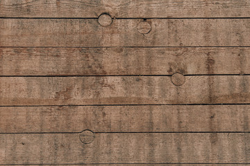 Wall Mural - Old brown wood background made of dark natural wood in grunge style. The view from the top. Natural raw planed texture of coniferous pine. The surface of the table to shoot flat lay. Copy space