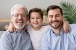 © fizkes - Happy male intergenerational 3 three generation men family portrait