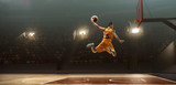 Basketball player on basketball court in action. Slam dunk. Jump shot