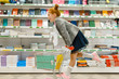 © Nomad_Soul - Schoolgirl with cart, shopping in stationery store
