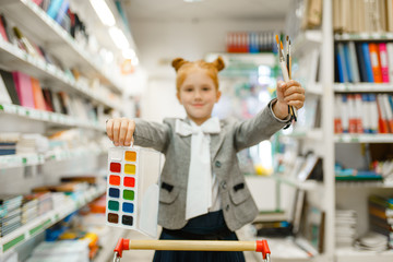 Wall Mural - School girl with paints and brushes, stationery