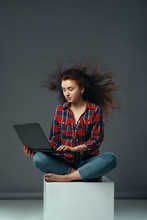 Strong Wind Blowing On Woman With Laptop