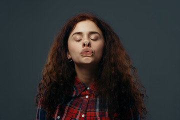 Woman's crazy face crushed on transparent glass