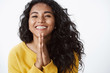 Happy grateful young cute african american girl thanking for help, very glad receive lovely gift, smiling joyfully, press palms together in pray, standing white background in yellow sweater