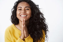 Happy Grateful Young Cute African American Girl Thanking For Help, Very Glad Receive Lovely Gift, Smiling Joyfully, Press Palms Together In Pray, Standing White Background In Yellow Sweater