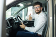 © F8  \ Suport Ukraine - Thumbs up. Portrait of a happy businessman showing thumbs up sitting in his new car