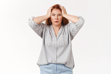 Wall Mural - What disaster. Shocked panic redhead woman grab head troubled frowning bothered feel pressured distress facing trouble terrible scene displeased huge mess kids made, standing white background