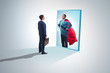 © Elnur - Businessman seeing himself in mirror as superhero