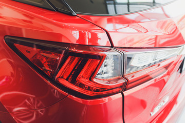 Wall Mural - Detail on the rear light of a red car.