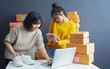 © sutthinon602 - Startup small business owner working with computer at workplace. Freelance two woman seller check product order. Packing goods for delivery to customer. Online selling. E-commerce. Online Shopping