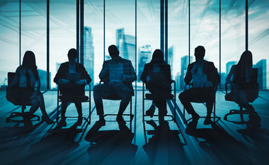 Wall Mural - Double exposure image of many business people conference group meeting on city office building in background showing partnership success of business deal. Concept of teamwork, trust and agreement.