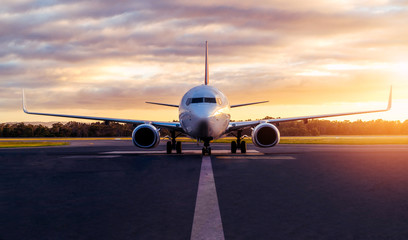 sunset view of airplane on airport runway under dramatic sky in hobart,tasmania, australia. aviation