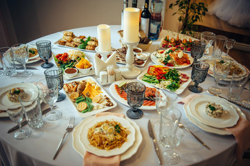 Beautifully served banquet table with a variety of snacks at corporate dinner, birthday party, Christmas party or wedding celebration.