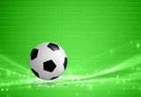 Fototapeta Sport - Soccer ball on green abstract background