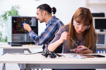 Two technicians working at computer warranty center