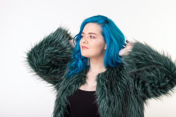 Canvas Print - Animal protection, fashion and hair concept - beautiful girl with blue hair dressed in artificial fur coat standing on white background