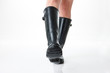 © photo_HYANG - Image of a woman's legs wearing rubber boots.