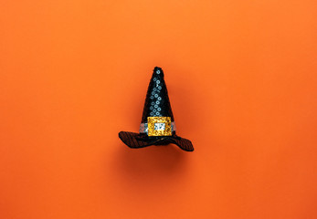 Fototapete - Table top view aerial image of Happy Halloween decorations festival concept background.Flat lay accessories essential object to party the black hat of witch on modern rustic orange paper.