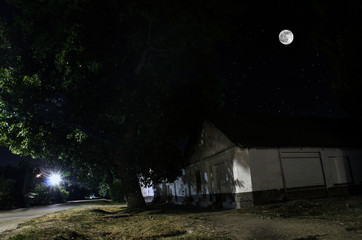 Wall Mural - full moon over quite village at night. beautiful night landscape of old town street with lights. rus