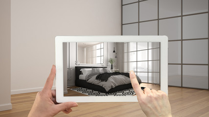 Wall Mural - augmented reality concept. hand holding tablet with ar application used to simulate furniture and de
