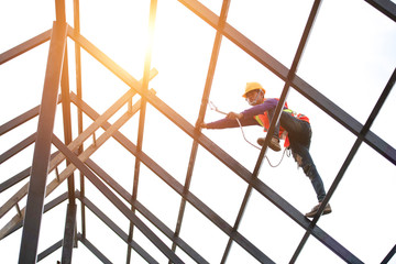 Wall Mural - Roof repairman, construction engineer wearing safety inspection kit in Asia