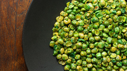 Canvas Print -  salted peas on black Ceramic Plate close up image.