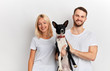 © alfa27 - positive happy couple with dog posing to the camera isolated over white background, close up portrait, studio shot. family with favourite pet. lifestyle