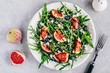 Arugula salad with figs, blueberries and goat cheese, balsamic sauce dressing