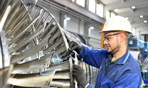 Fotomural workers manufacturing steam turbines in an industrial factory