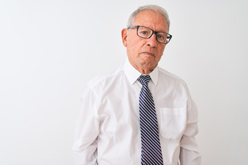 Sticker - Senior grey-haired businessman wearing tie and glasses over isolated white background with serious expression on face. Simple and natural looking at the camera.