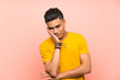 © luismolinero - Young man with yellow shirt over isolated pink wall unhappy and frustrated