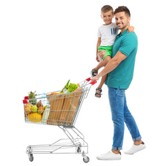 Poster - Father and son with full shopping cart on white background