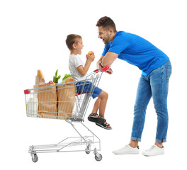 Wall Mural - Father and son with full shopping cart on white background