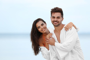 Sticker - Happy young couple spending time together on beach