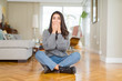 © Krakenimages.com - Young beautiful woman sitting on the floor at home shocked covering mouth with hands for mistake. Secret concept.