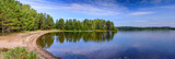 Fototapeta Na ścianę - A wide panorama of a beautiful forest lake in Finland. Traditional Finnish nature, beautiful summer landscape.