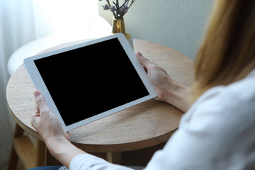 Business woman using tablet  with holding on wooden desk