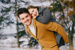 © prostooleh - happy young couple walking through the park on a snowy day