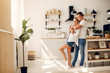 © prostooleh - Cute couple in a kitchen. Lady in a white shirt. Pair at home