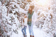 © alexkich - Young family for a walk. Mom and daughter are walking in a winter park.