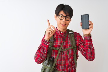 Wall Mural - Chinese hiker man wearing canteen holding smartphone over isolated white background surprised with an idea or question pointing finger with happy face, number one