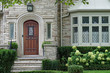 stone faced house with leaded glass windows and elegant wooden front door