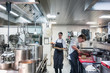© Kzenon Premium - Two chefs preparing and serving high quality food while working in the kitchen of a restaurant