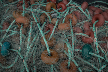 Close up fishing green nets with rope and orange and green floatings