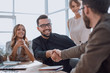 © ASDF - background image of the handshake of business partners in the office