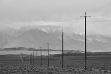 Power Lines Stretching Across The Empty And Desolate California Desert